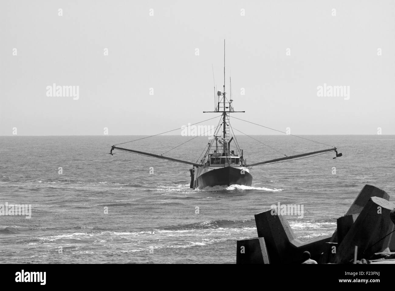 A commercial fishing trawler returning from work and about to enter the