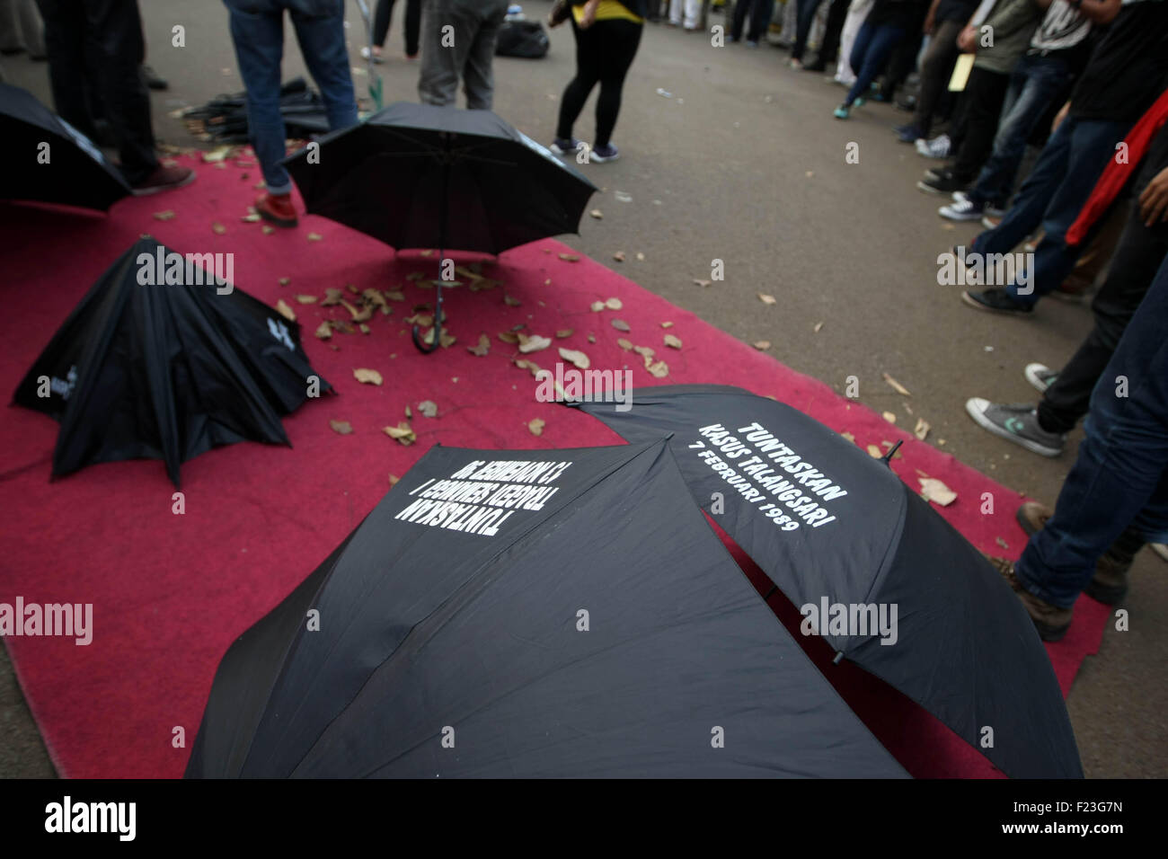 Central Jakarta, Jakarta, Indonesia. 14th Feb, 2013. Human rights activists during the gathered for the 411th time in front of the Presidential Palace in Jakarta for the weekly Kamisan (Thursdays). Kamisan (with black umbrella is symbol) was initiated in January 2007 by families of victims of human rights violations, and is supported by human rights organisations such as The Commission for the Disappeared and Victims of Violence (KontraS). The protest brings together individuals concerned with various human rights cases: from those committed during Soeharto's New Order, such as the 1965/196 Stock Photo