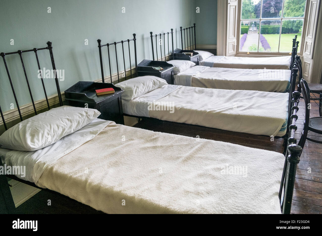 regular uniform row of beds in dormitory bedroom Stock Photo
