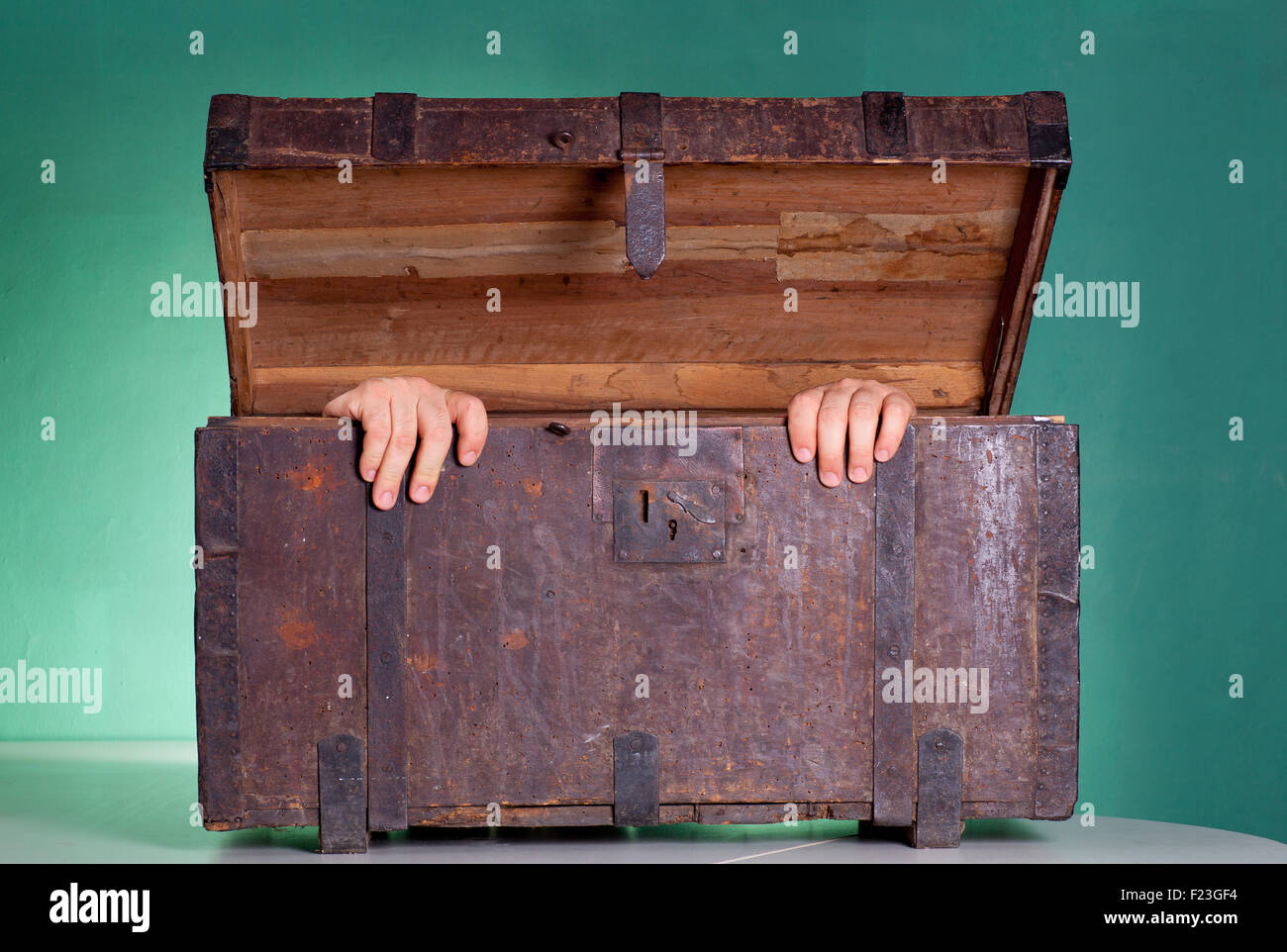 Hands coming out the Antique wooden trunk Stock Photo