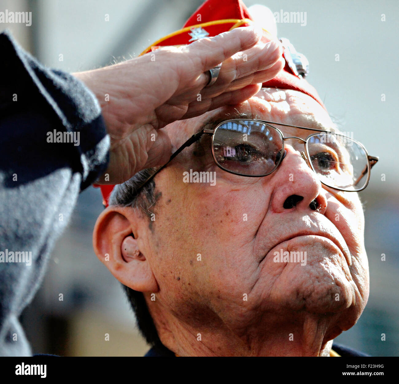 U.S. Marine Corps Cpl. Frank G. Willetto salutes during the playing of the national anthem at a ceremony commemorating the 65th anniversary of the Battle of Iwo Jima at the National Museum of the Marine Corps February 19, 2010 in Triangle, Virginia. Willetto was one of the original 29 Navajo Code Talkers of World War II. Stock Photo