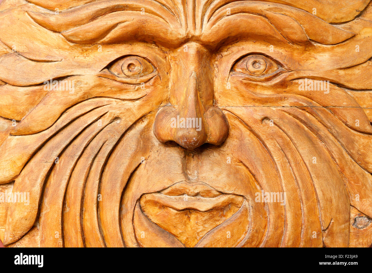 Close up of a carved wooden sun face Stock Photo