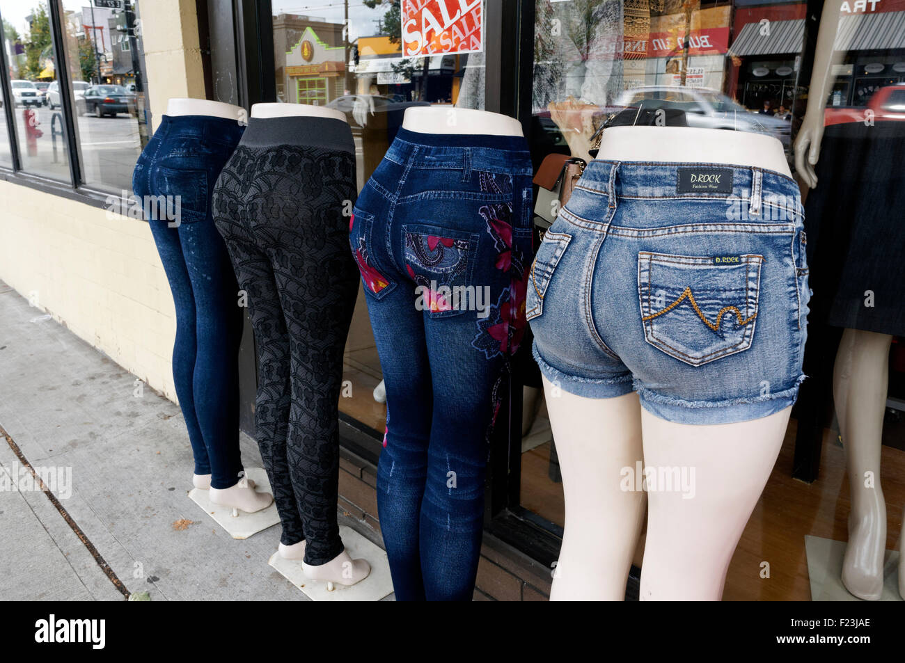 Rear view of mannequins fitted with women's denim blue jeans in front