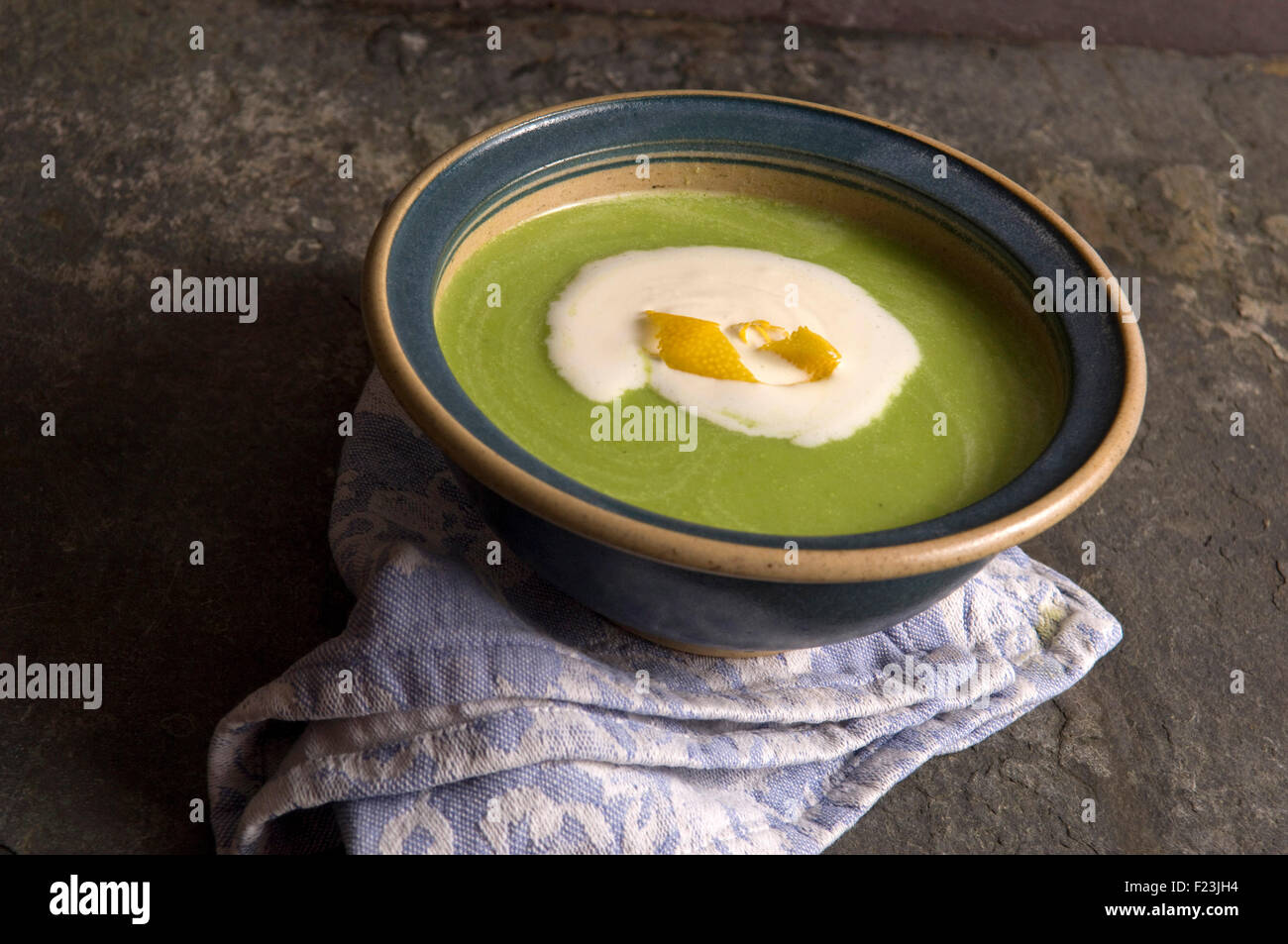 Pea soup with cream and orange peel. a UK food vegetable bowl meal 'small plate' dish eating cooking Stock Photo