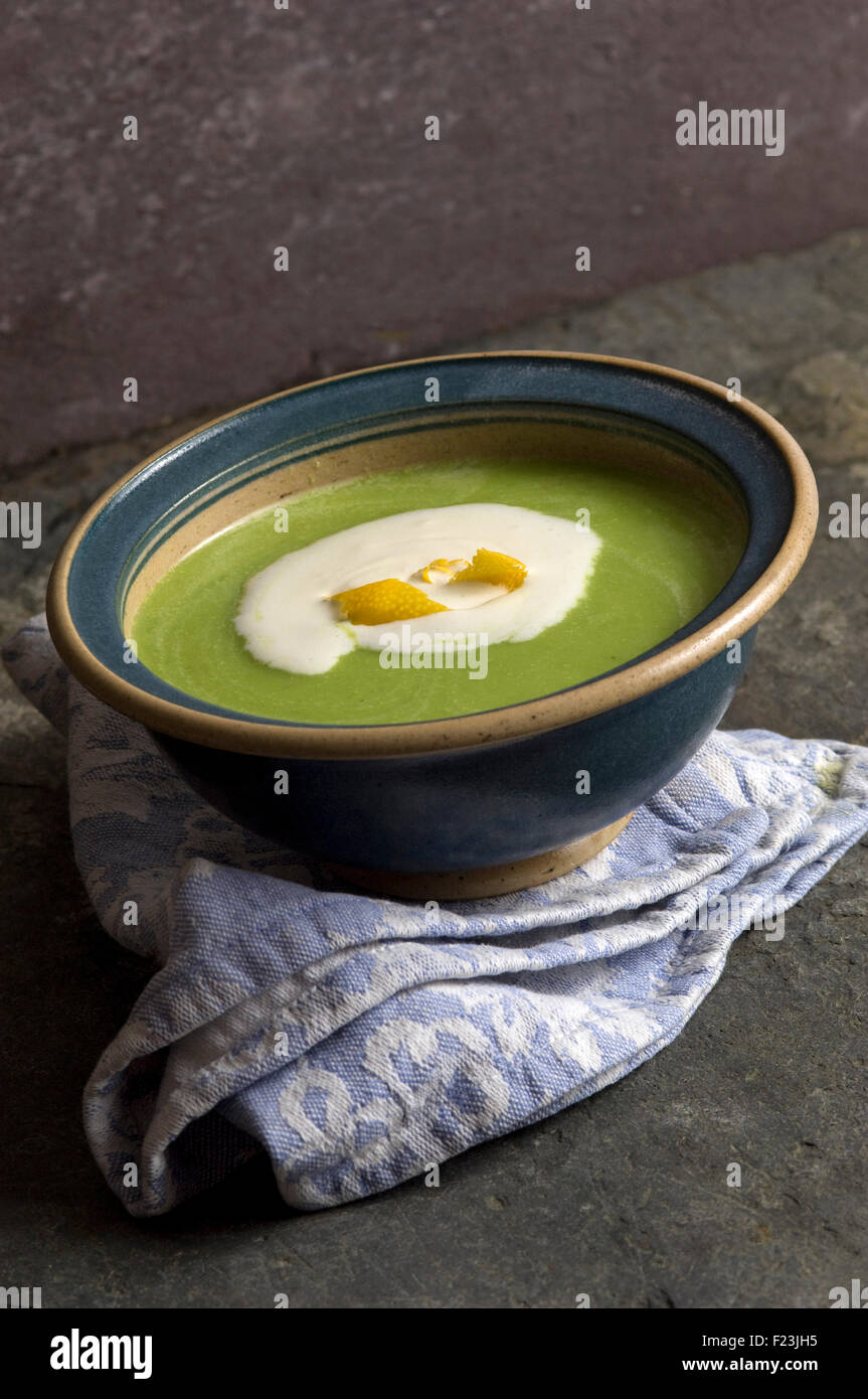 Pea soup with cream and orange peel. a UK food vegetable bowl meal 'small plate' dish eating cooking Stock Photo