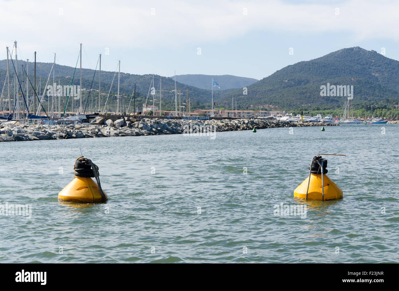 Two yellow buoys floating on a sea Stock Photo