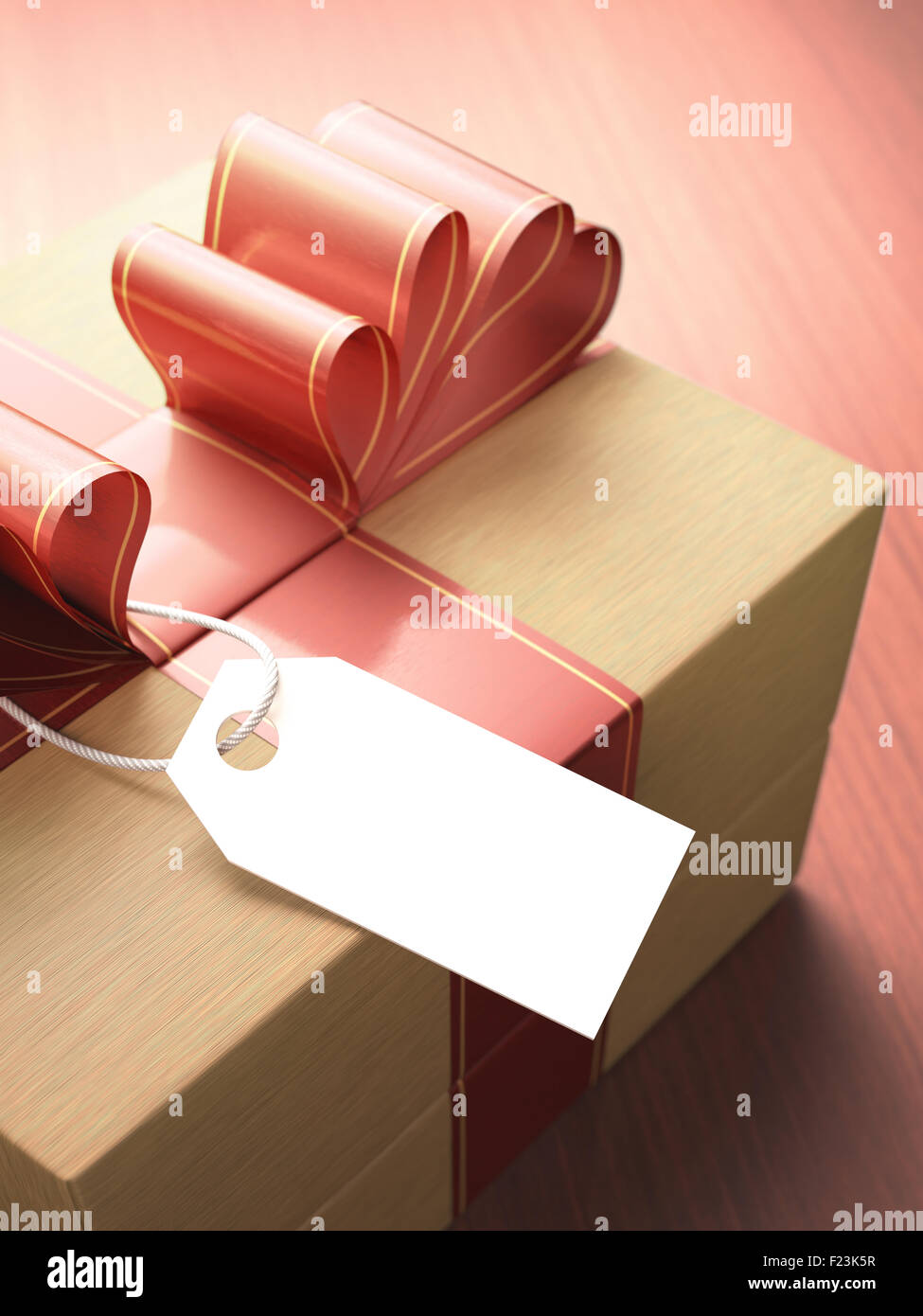 Gift with red ribbon and a blank card waiting for your message. Depth of field with focus on the card. Clipping path included. Stock Photo