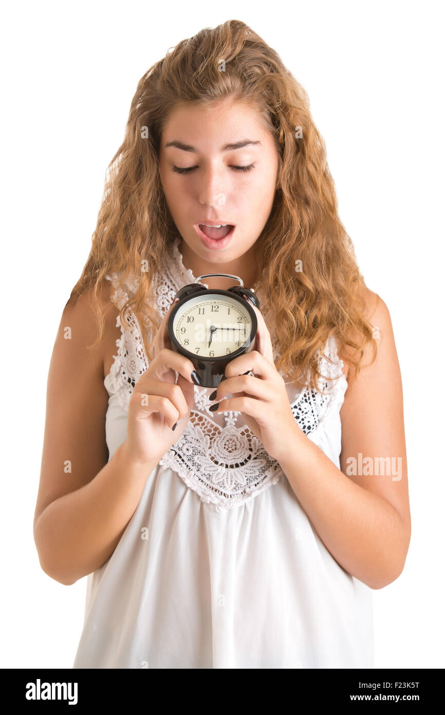 Woman looking surprise at an alarm clock isolated Stock Photo