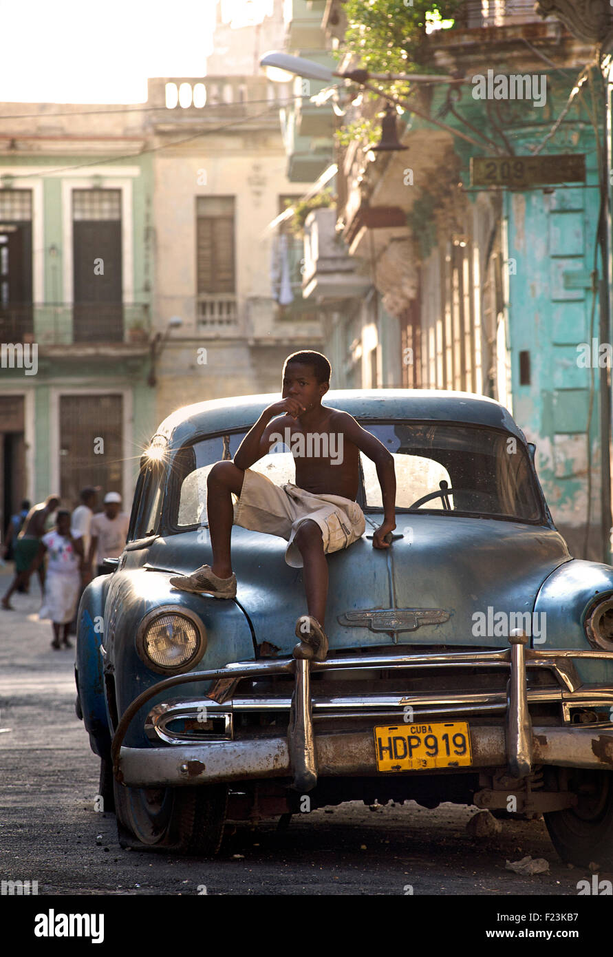 Cuban boy on a classic American car. CHEVROLET. A cultural icon for modern day Cuba. Havana, Cuba Stock Photo