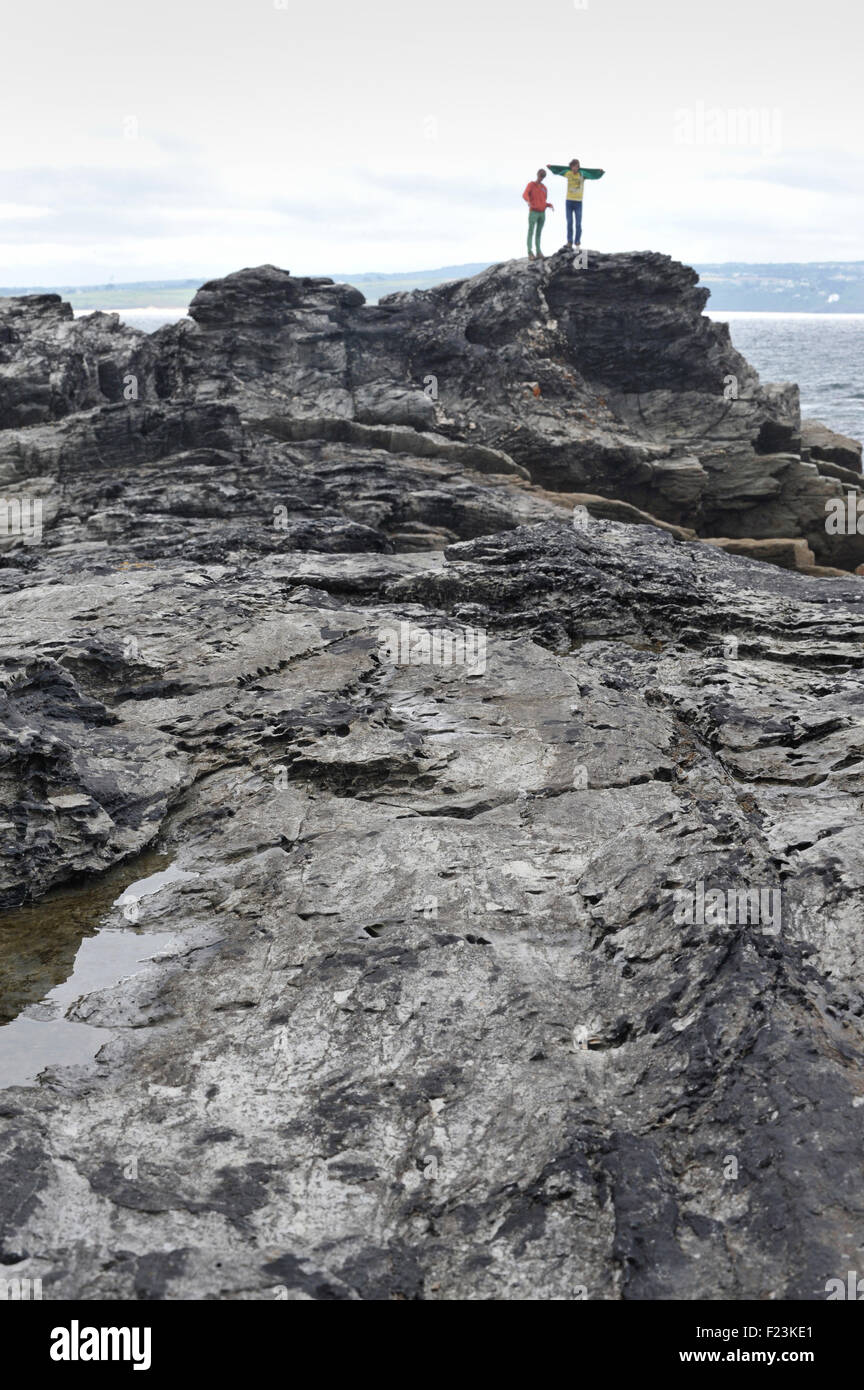 Children climbing on rocks, Cornwall, England. UK Stock Photo Alamy