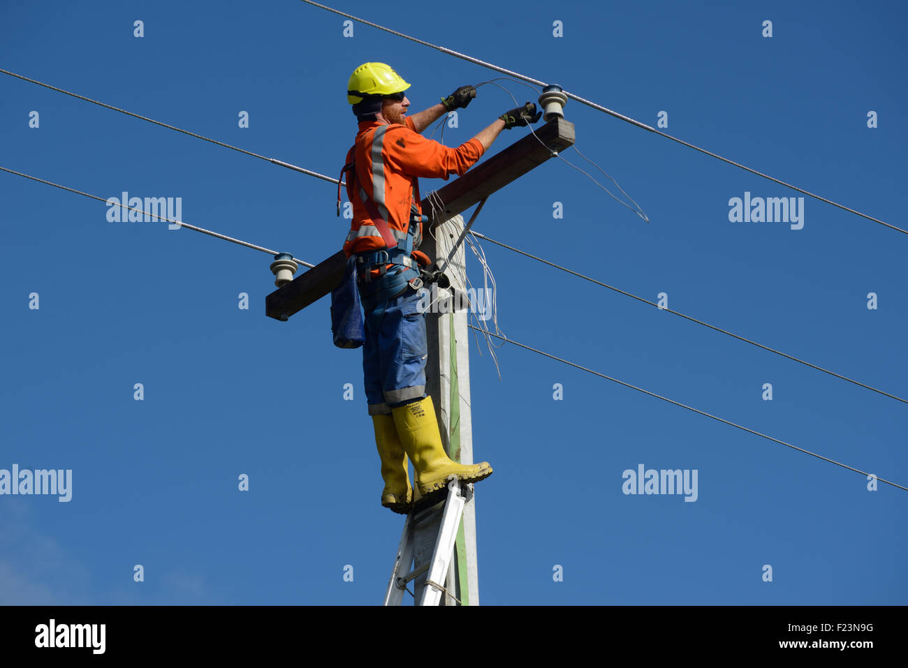 GREYMOUTH, NEW ZEALAND, AUGUST 5, 2015 A linesman wires up a mains