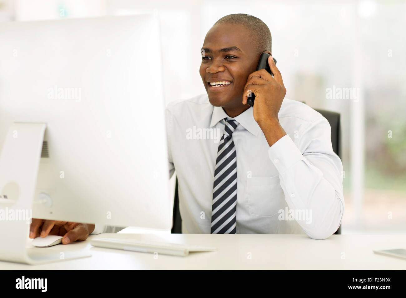 smiling African American businessman making phone call Stock Photo - Alamy