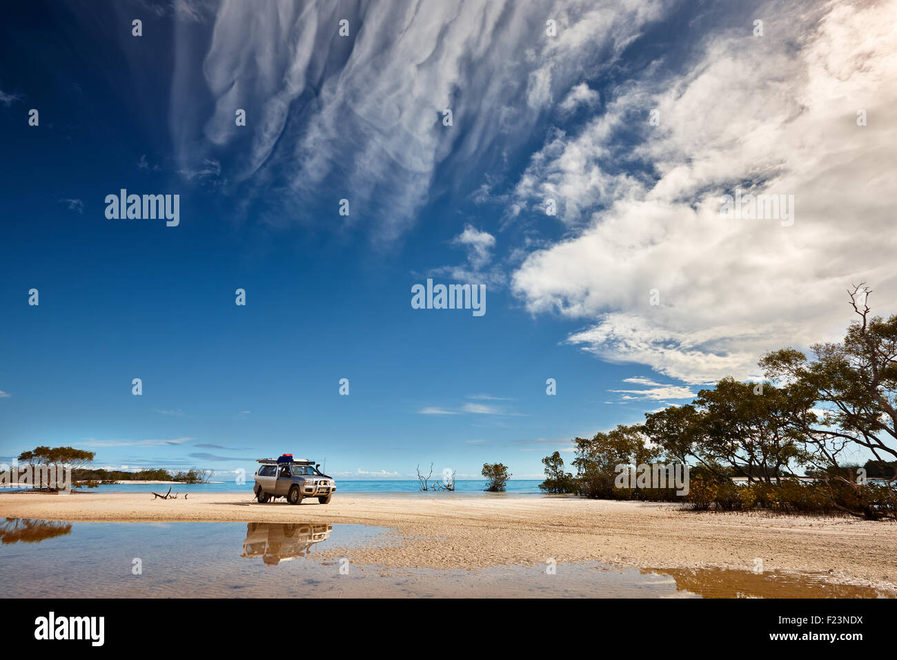 Four wheel drive vehicle parked on the white beach sand at Wathumba Creek. Situated on the western side of Fraser Island and she Stock Photo