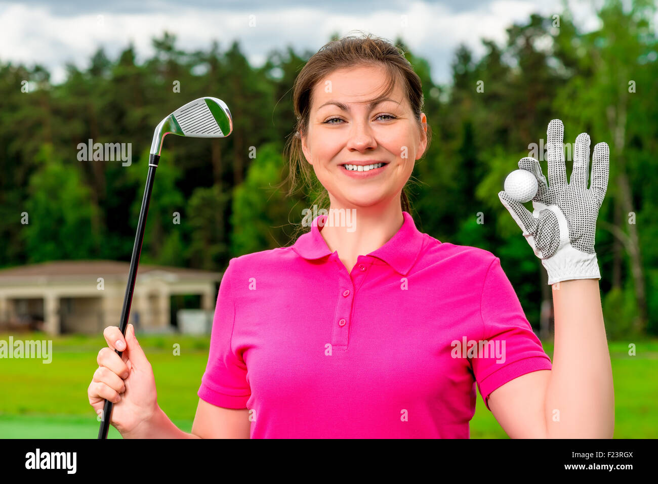 beautiful girl with a golf equipment smiling Stock Photo - Alamy