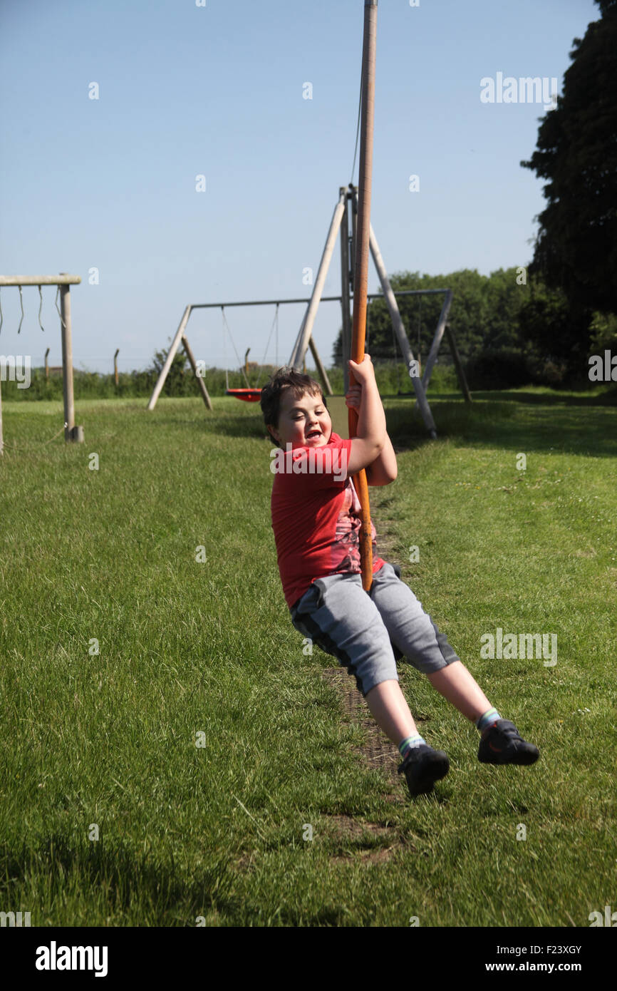 Small boy on zip wire at council play area Stock Photo