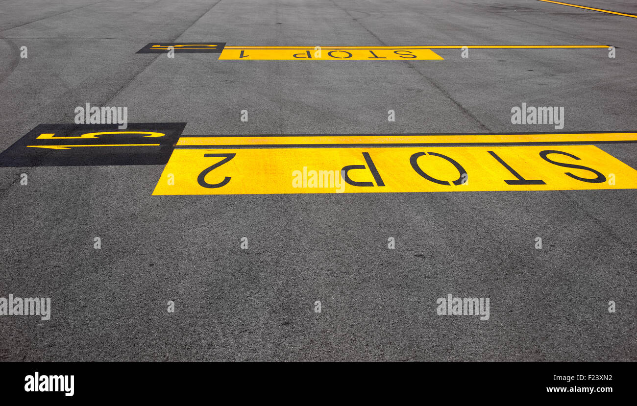 Yellow stop sign painted on the road Stock Photo