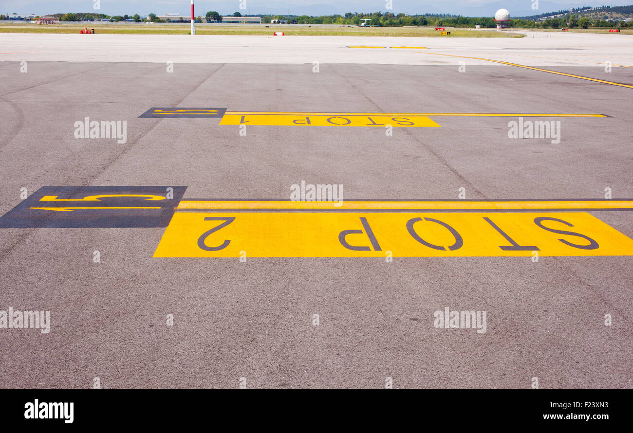 Yellow stop sign painted on the road Stock Photo