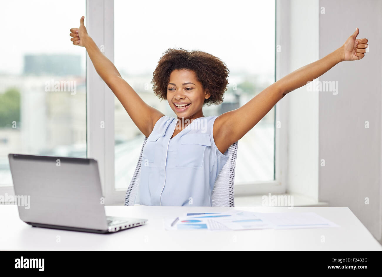 happy african woman with laptop at office Stock Photo - Alamy
