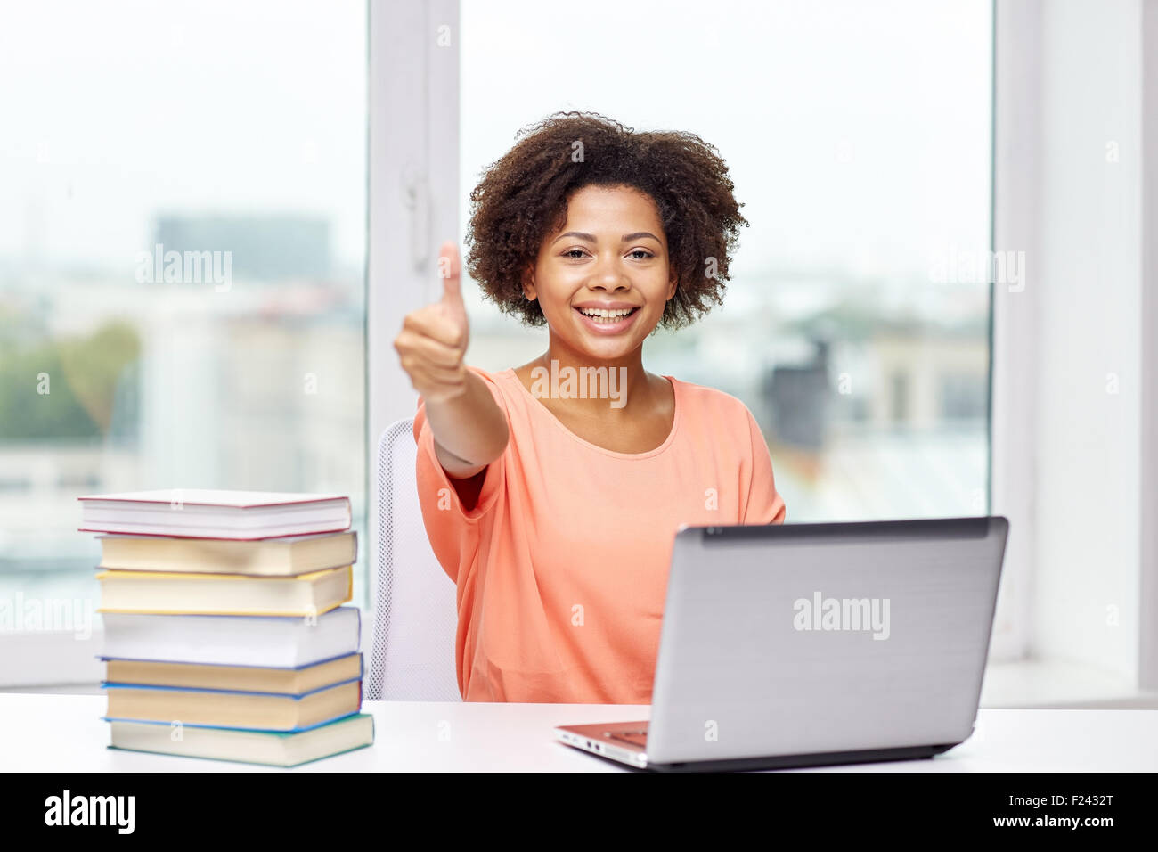 happy african american woman with laptop at home Stock Photo - Alamy