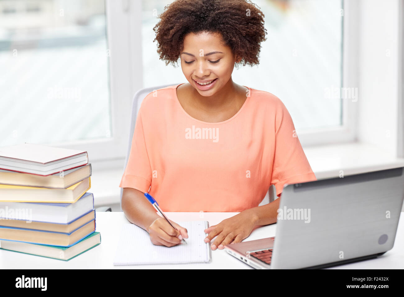 happy african american woman with laptop at home Stock Photo - Alamy