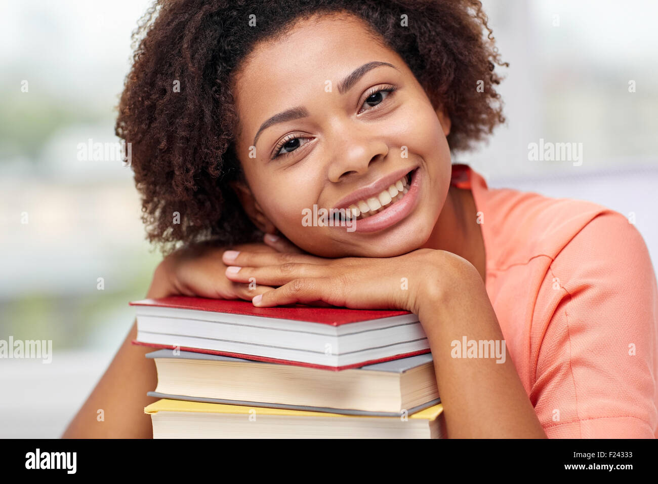 happy african student girl with books at home Stock Photo - Alamy