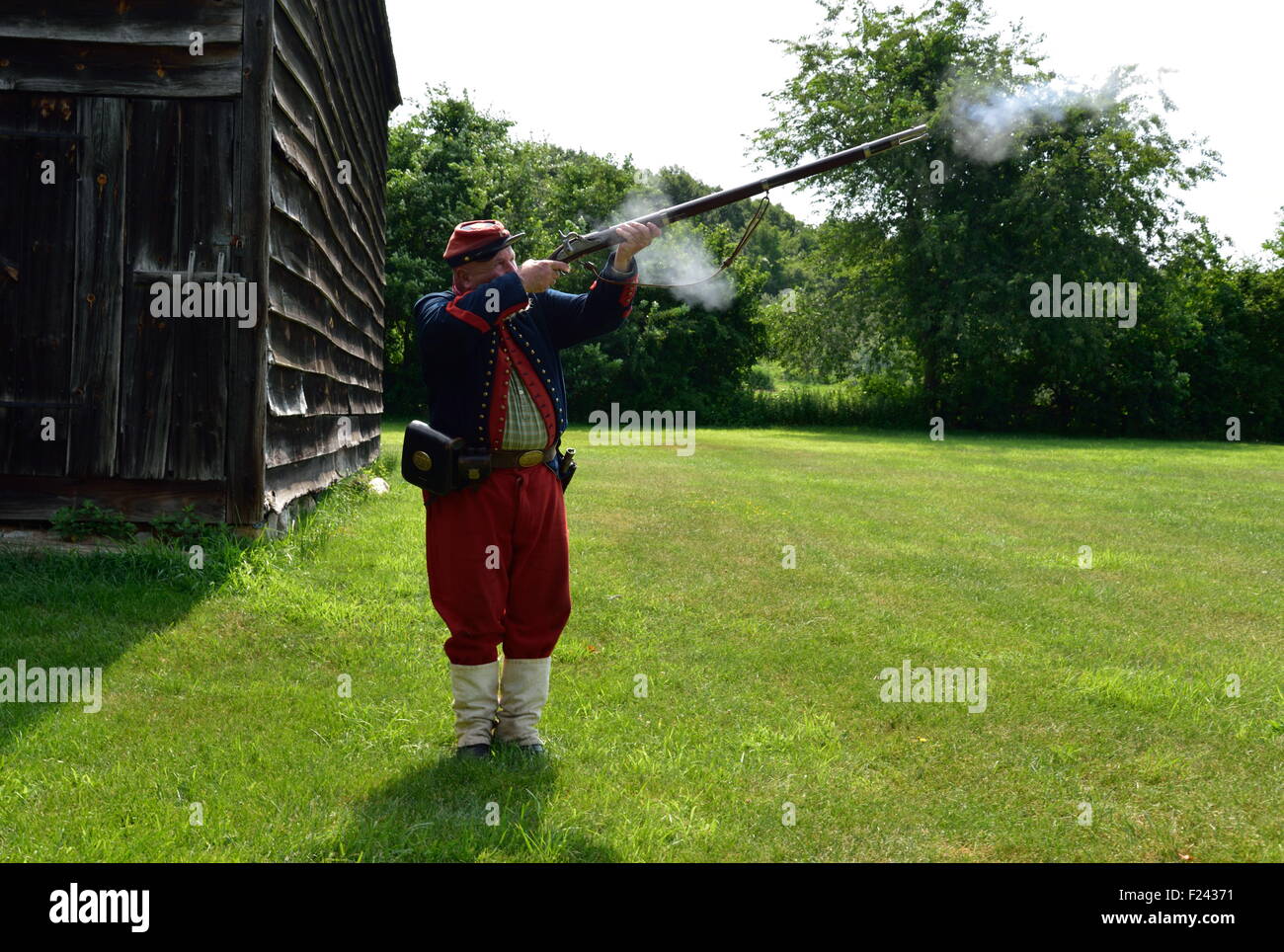 soldier firing his musket during a civil war commemoration at the old Bethpage village restoration Long Island Stock Photo