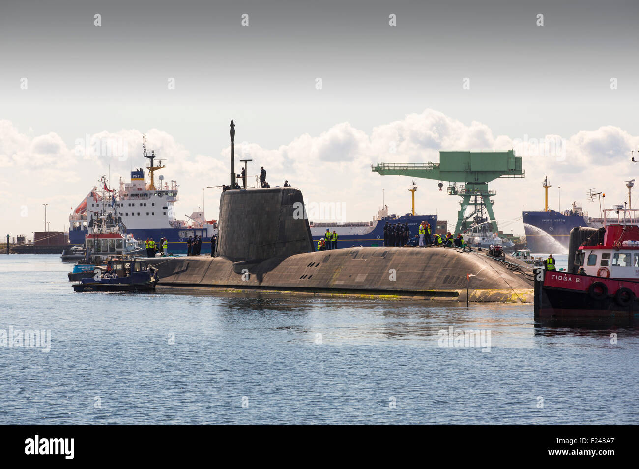The Artful an Astute class hunter killer nuclear powered submarine is moved from BAE Systems in Barrow in Furness up to the Faslane submarine base in Scotland, UK. The submarines are armed with Spearfish torpedoes and Tomahawk Cruise missiles. This shot shows the Pacific Heron a nuclear transport ship behind. Stock Photo