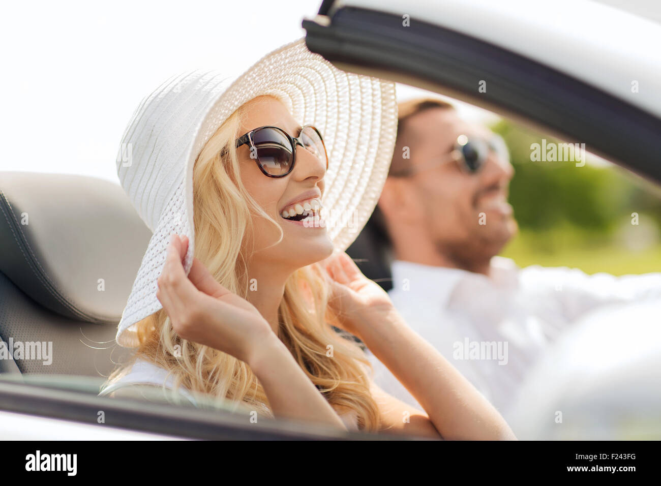 happy man and woman driving in cabriolet car Stock Photo