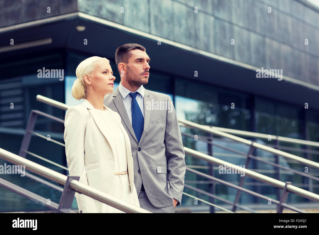 serious businessmen standing over office building Stock Photo - Alamy