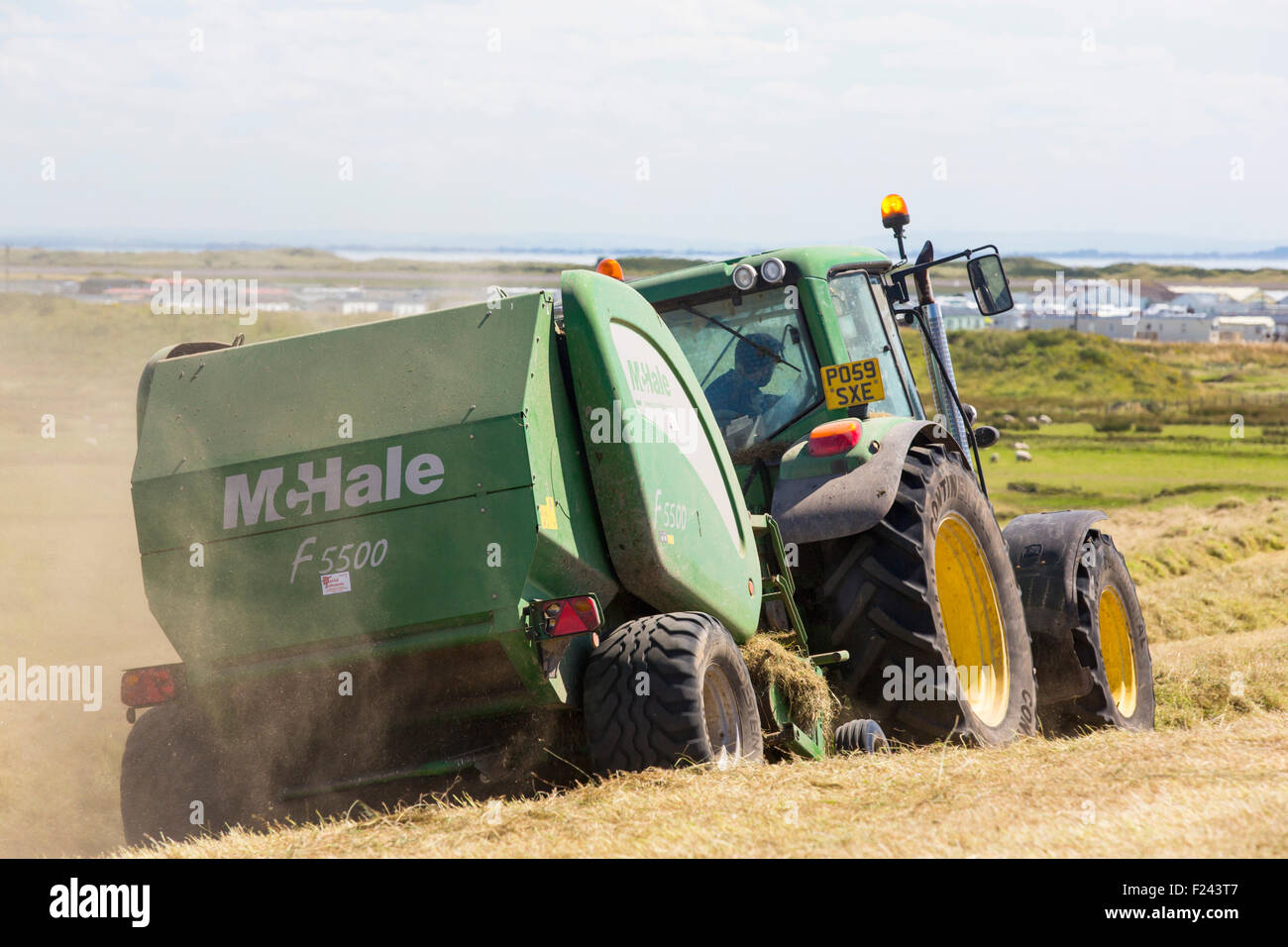 Farmer Harvesting His Hay Field With A Tractor High Resolution Stock ...