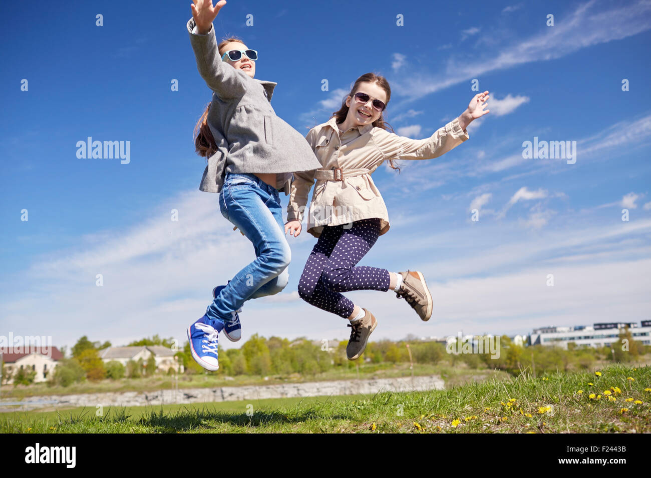 happy little girls jumping high outdoors Stock Photo - Alamy