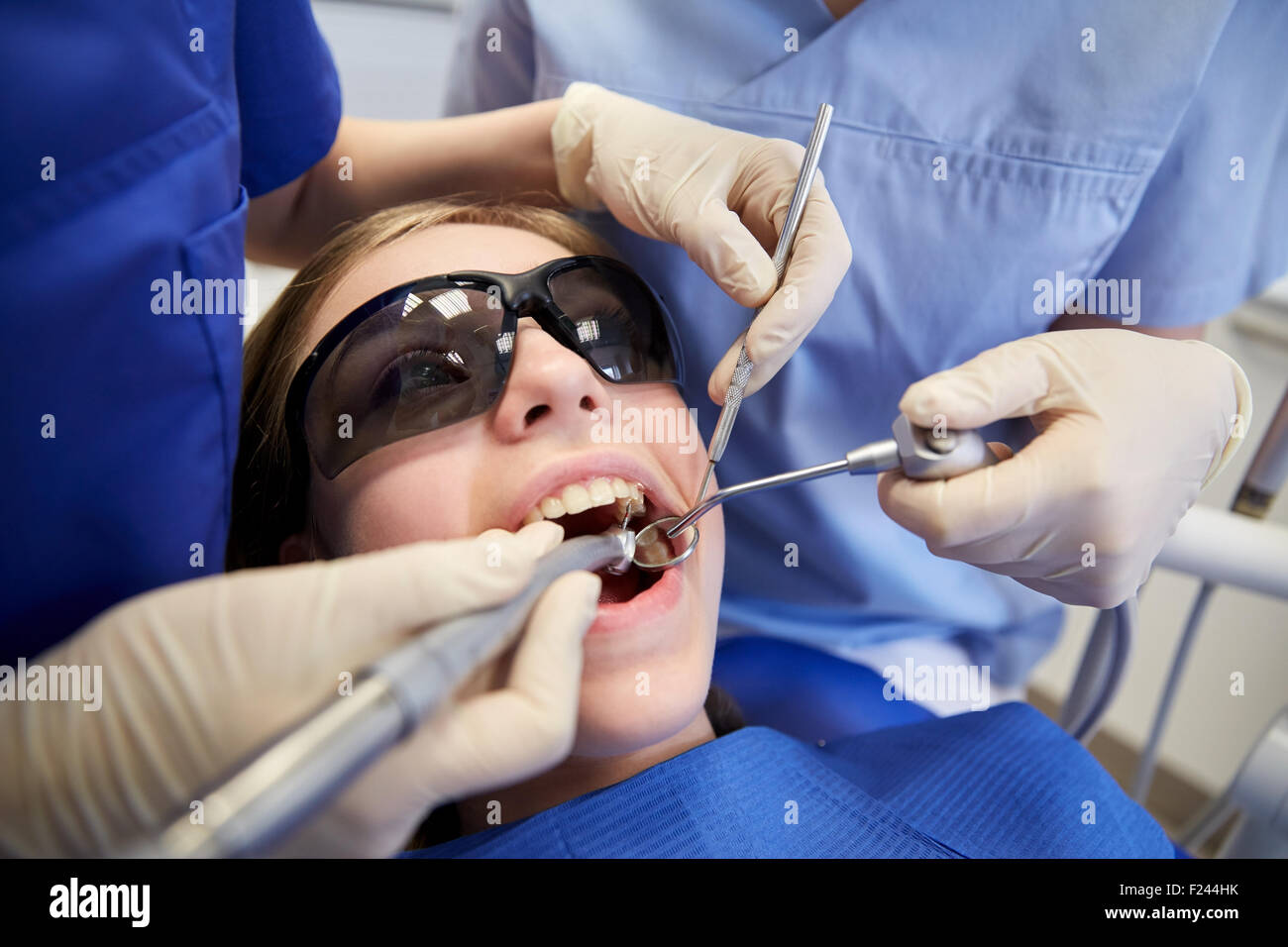 female dentists treating patient girl teeth Stock Photo Alamy