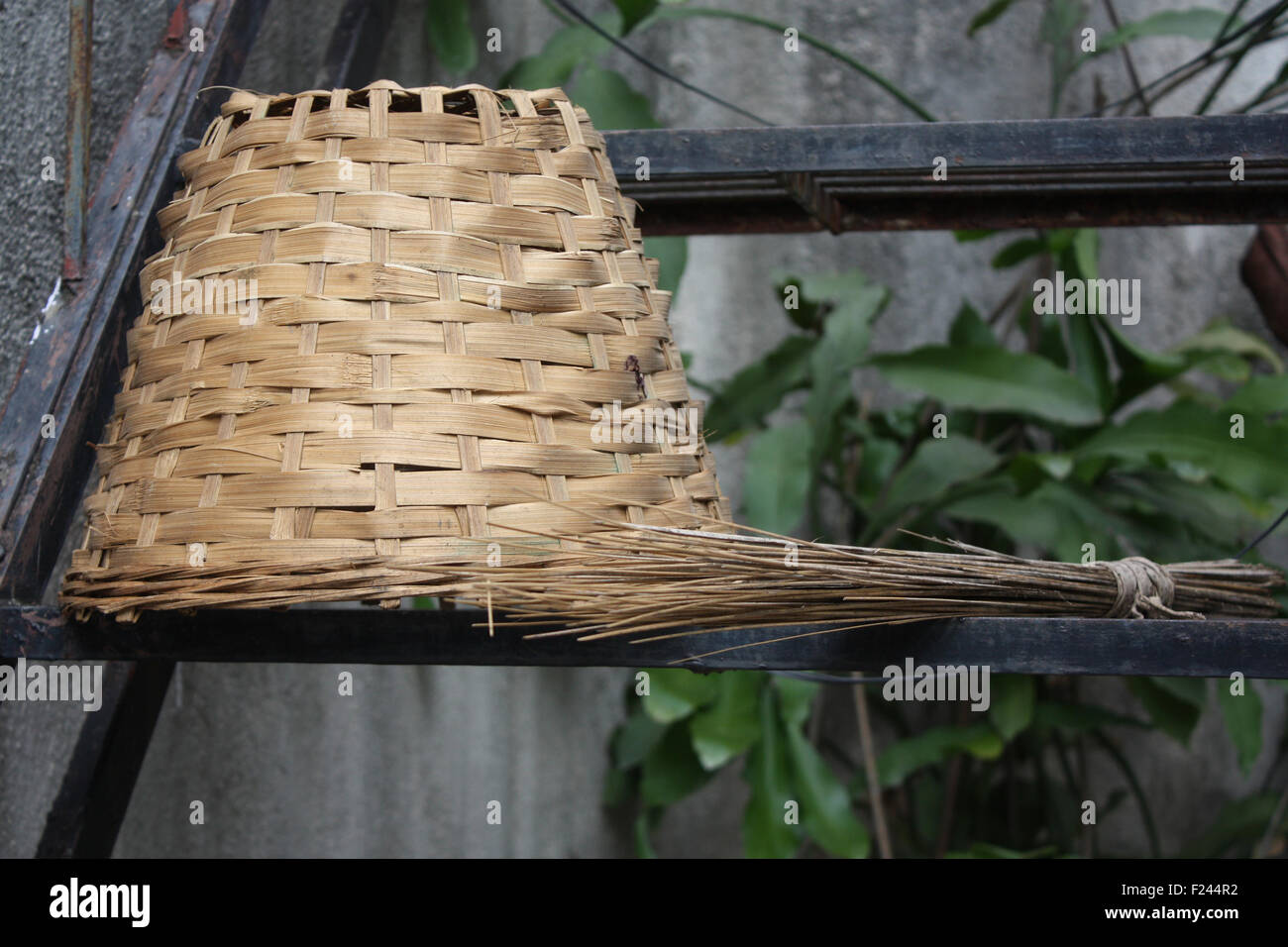 An old cane basket and a broom for cleaning Stock Photo Alamy
