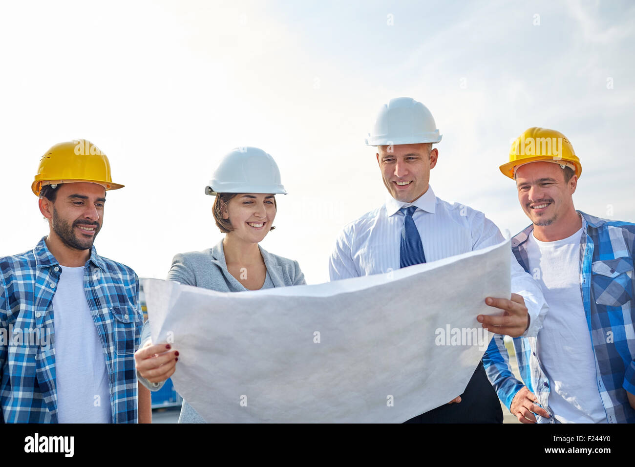 group of builders and architects with blueprint Stock Photo Alamy
