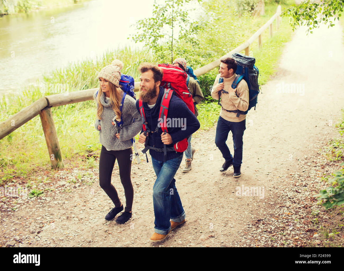 group of smiling friends with backpacks hiking Stock Photo - Alamy