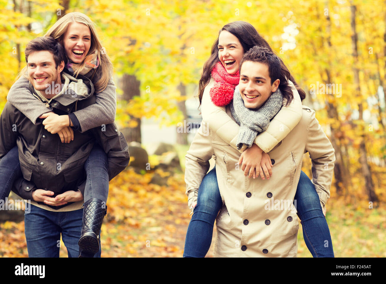 smiling friends having fun in autumn park Stock Photo - Alamy