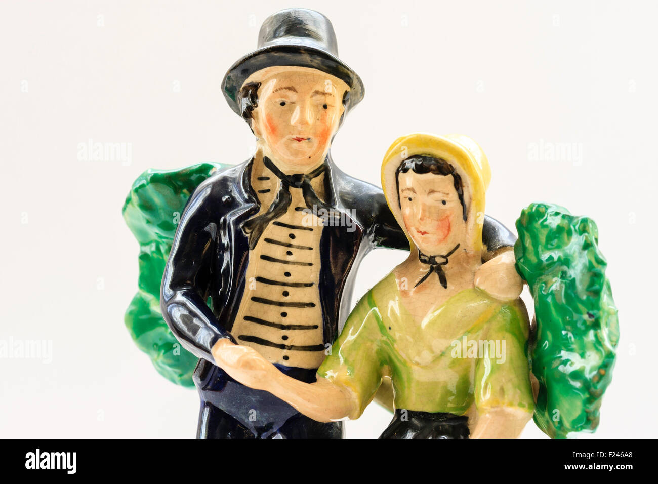 Ceramic figures. The Sailor's Return, 1757, standing British sailor with arm around sitting woman against backdrop of a bush. Stock Photo