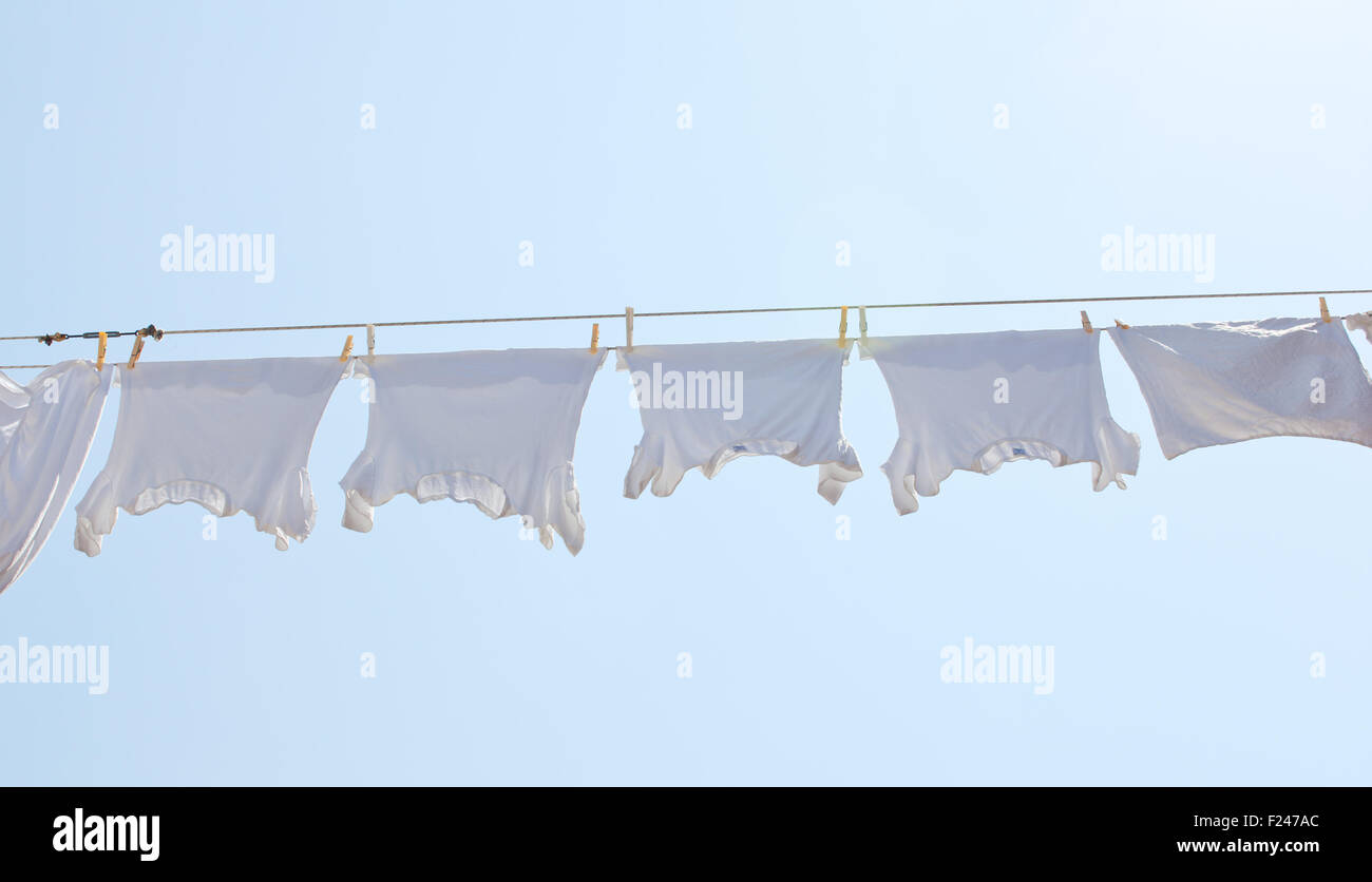 White tshirt hanging to dry on a clothesline Stock Photo Alamy