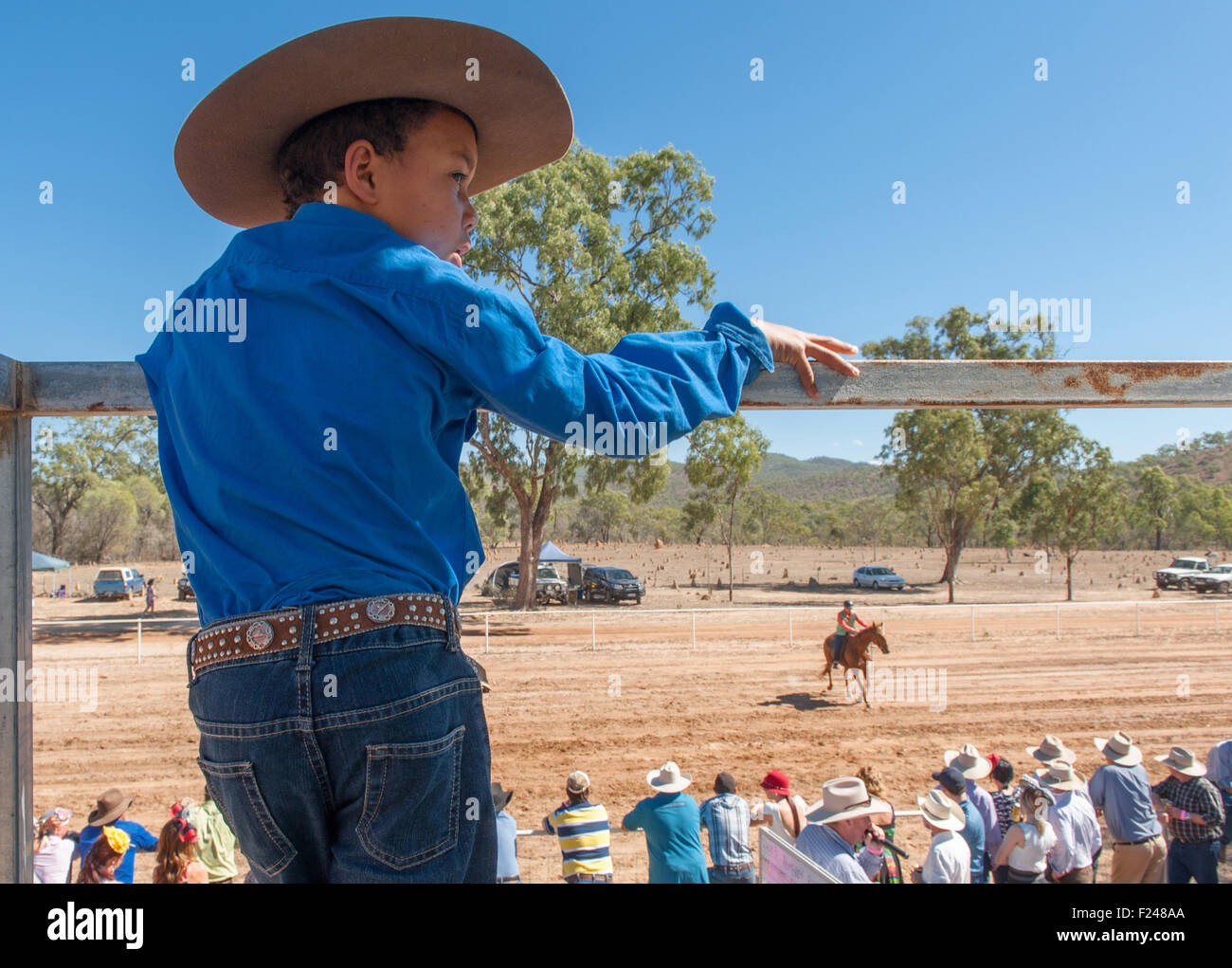 Young boy watching the bush races at the Eureka Creek Rodeo in late July, northern Queensland, Australia Stock Photo