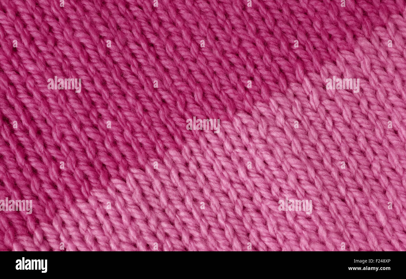 Stockinette knitting stitch with colour change from magenta to pink as an abstract background texture Stock Photo