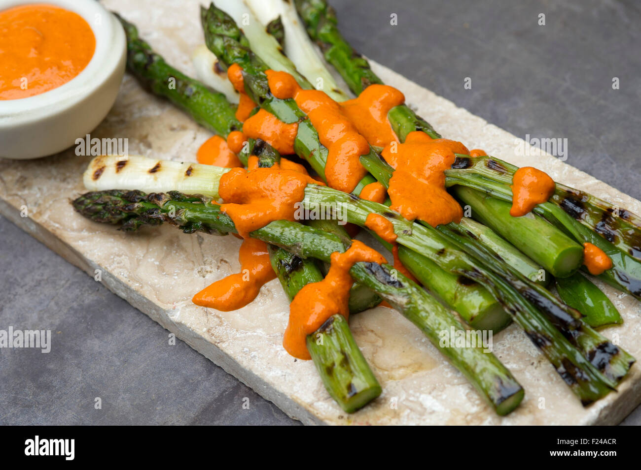 Paleo foods, asparagus, spring onion & raw romesco sauce Stock Photo