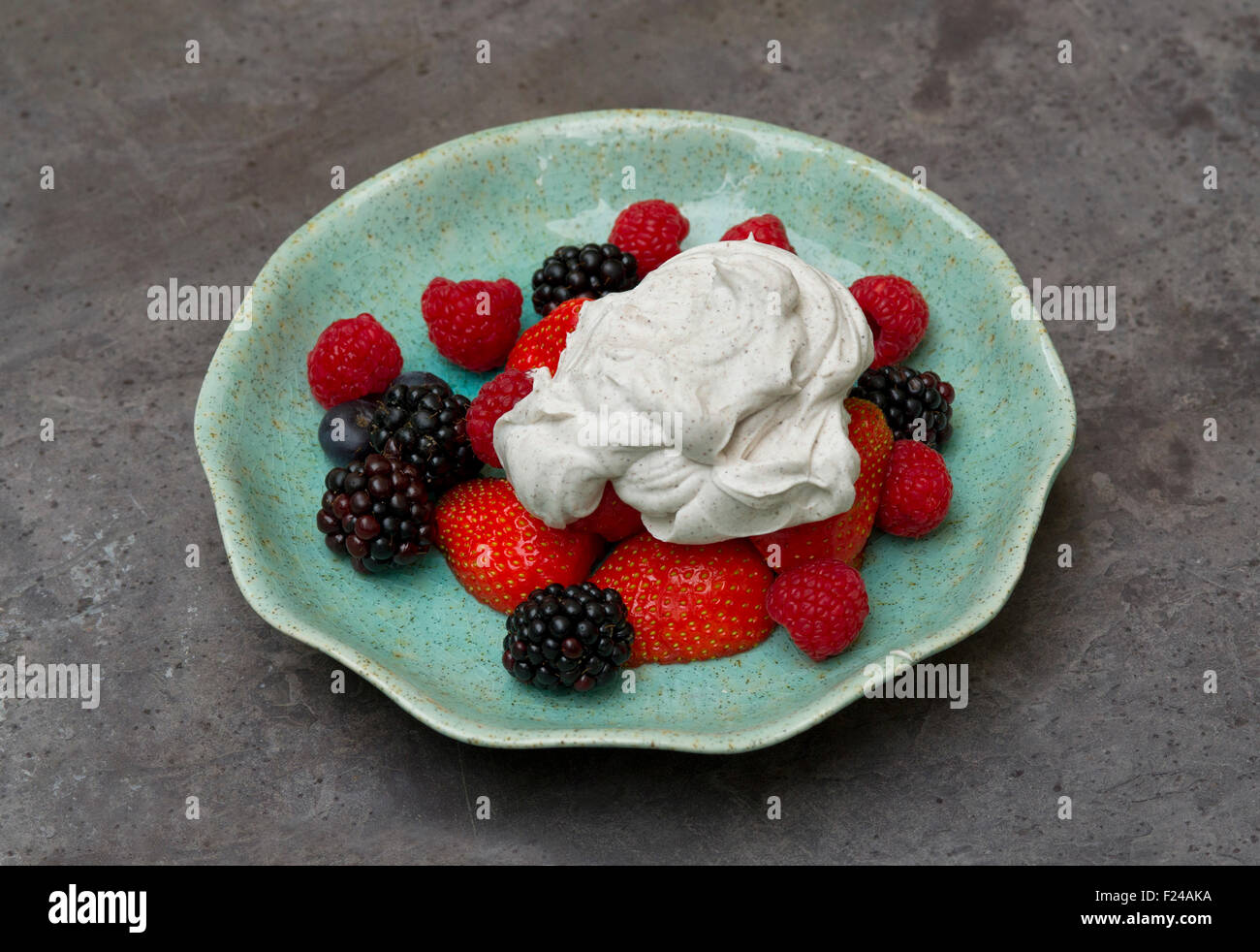 Paleo diet food, paleo cream with a selection of fruit berries, supposed based on 'cave man' Palaeolithic food. a UK dessert Stock Photo