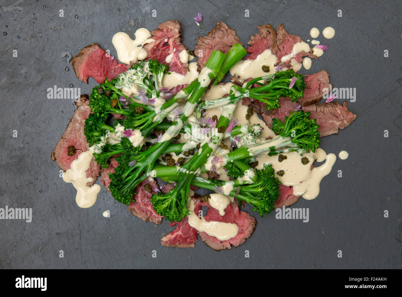 Paleo diet food, beef tonnato with broccoli, supposedly based on 'cave man' Palaeolithic foods for health. a UK Stock Photo