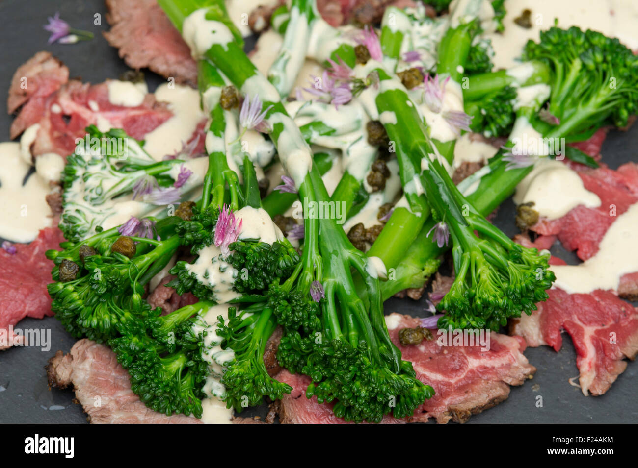 Paleo diet food, beef tonnato with broccoli, supposedly based on 'cave man' Palaeolithic foods for health. a UK Stock Photo