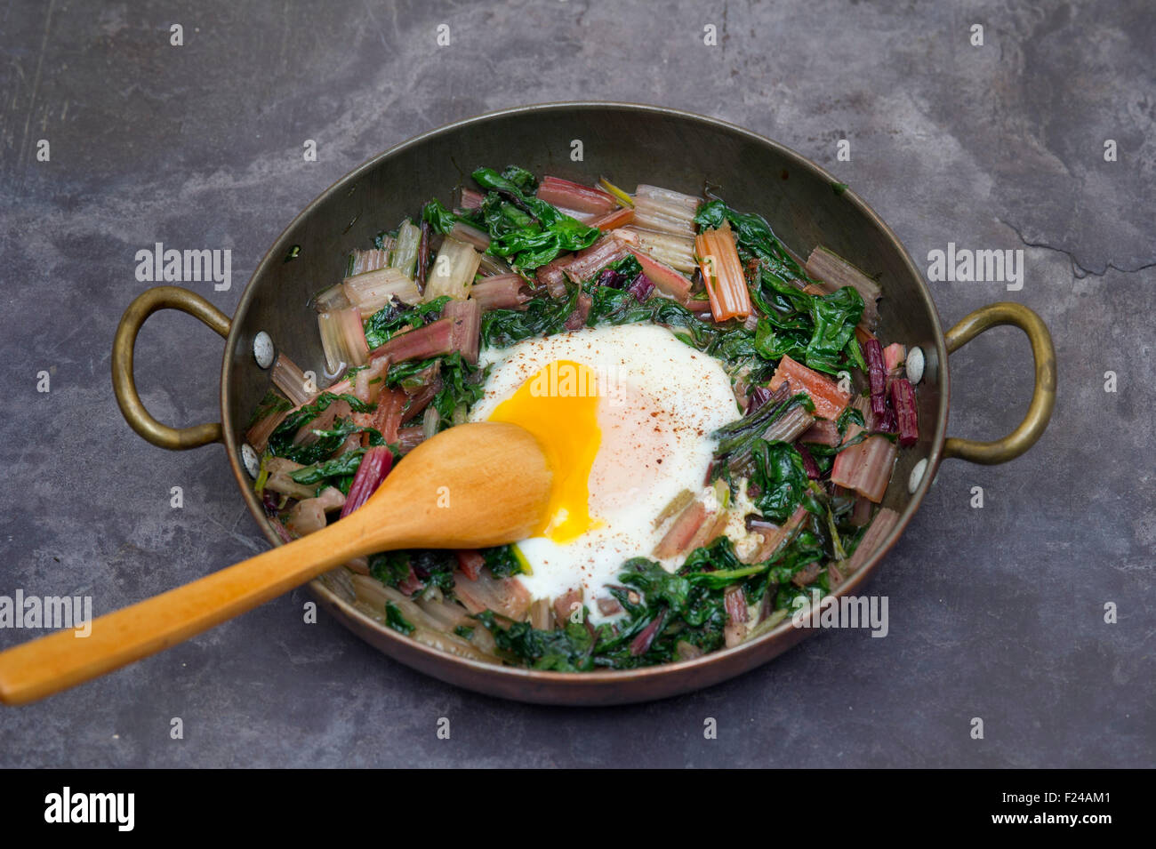 Paleo diet food, Swiss rainbow chard with a poached egg on top. This diet uses supposedly 'cave man' or Palaeolithic foods. a UK Stock Photo