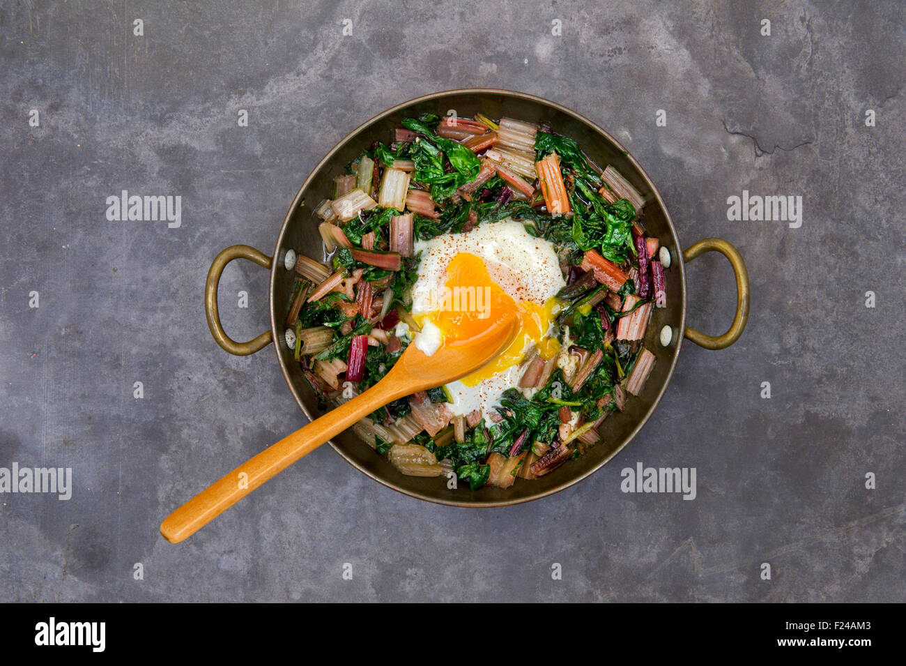 Paleo diet food, Swiss rainbow chard with a poached egg on top. This diet uses supposedly 'cave man' or Palaeolithic foods. a UK Stock Photo