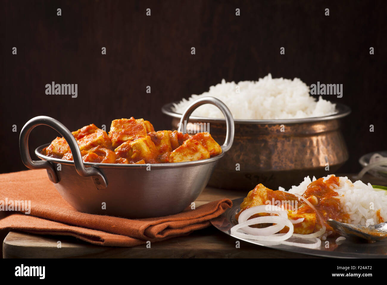Paneer and sweet pepper curry with rice on wooden background Stock Photo