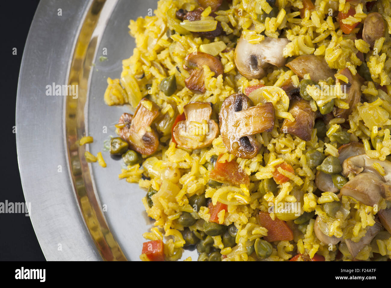 Biryani with indian spices, raisins and mushrooms served on stainless