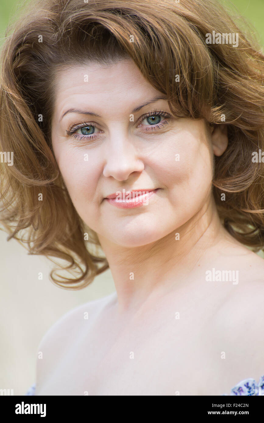 middleaged woman in the summer park Stock Photo Alamy
