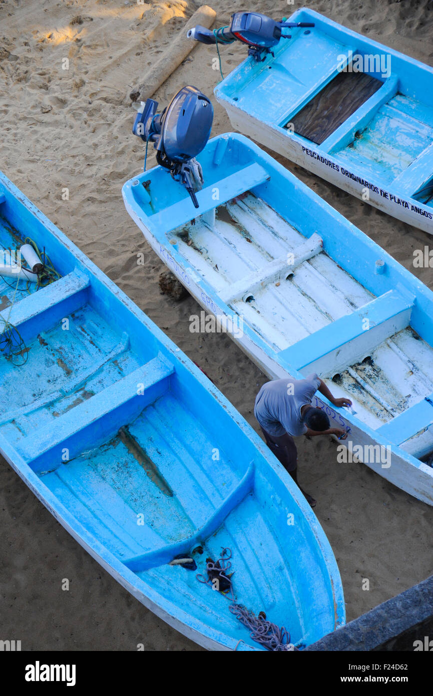 Fishing boats on the Playa La Angosta beach located in a small cove opening directly into the Pacific Ocean in Acapulco, Mexico. Stock Photo
